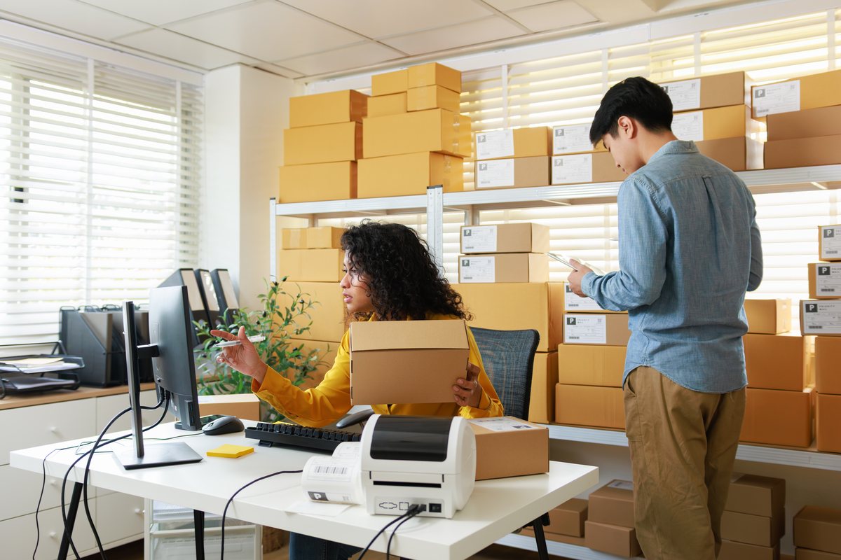 Business team packing and shipping orders inside a small bay unit on Long Island